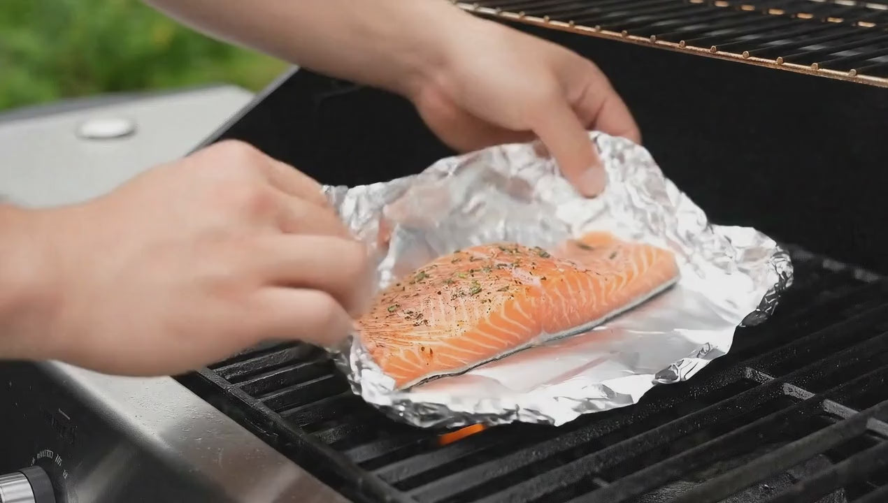 Load video: Heavy-duty foil wrapping containing seasoned meat ready for the grill